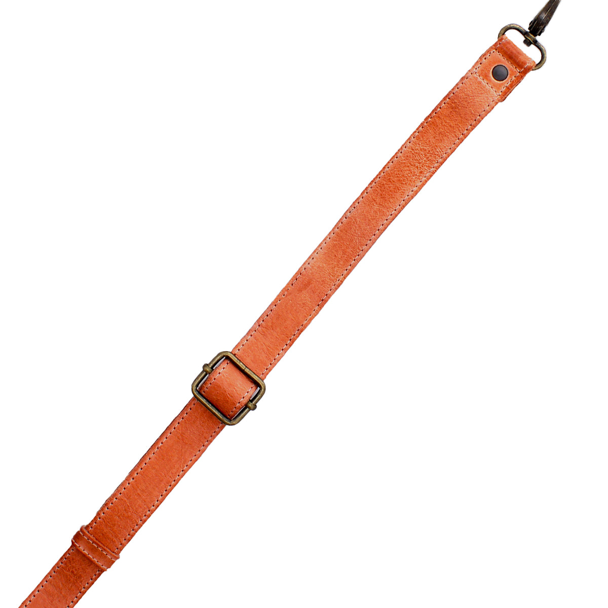 The Bed|Stü Crossbody Strap is a brown adjustable leather accessory featuring a metal buckle and clasp, designed for use with Bed|Stü bags, and is displayed diagonally on a white background.