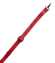 A red leather Crossbody Strap by Bed|Stü, featuring an adjustable length with a metal buckle and clasp, serves as a perfect replacement for Bed|Stü bags or any crossbody and is photographed on a white background.