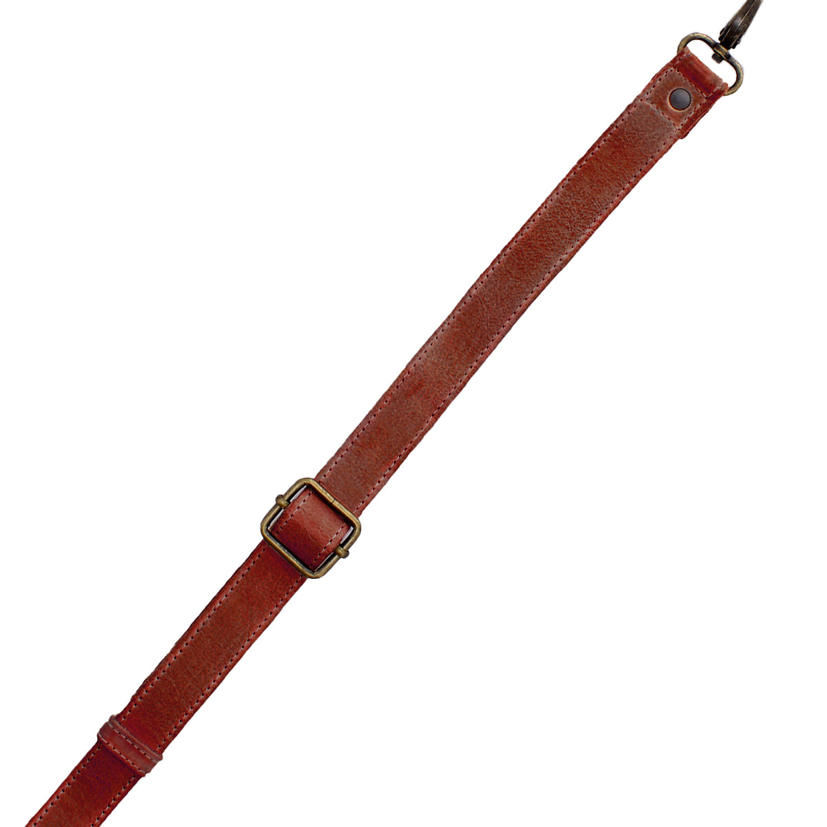 The Bed|Stü Crossbody Strap features a brown leather adjustable design with a brass buckle and metal clasp, displayed diagonally on a white background—ideal as an adjustable leather strap for Bed|Stü bags or as a fashionable crossbody accessory.