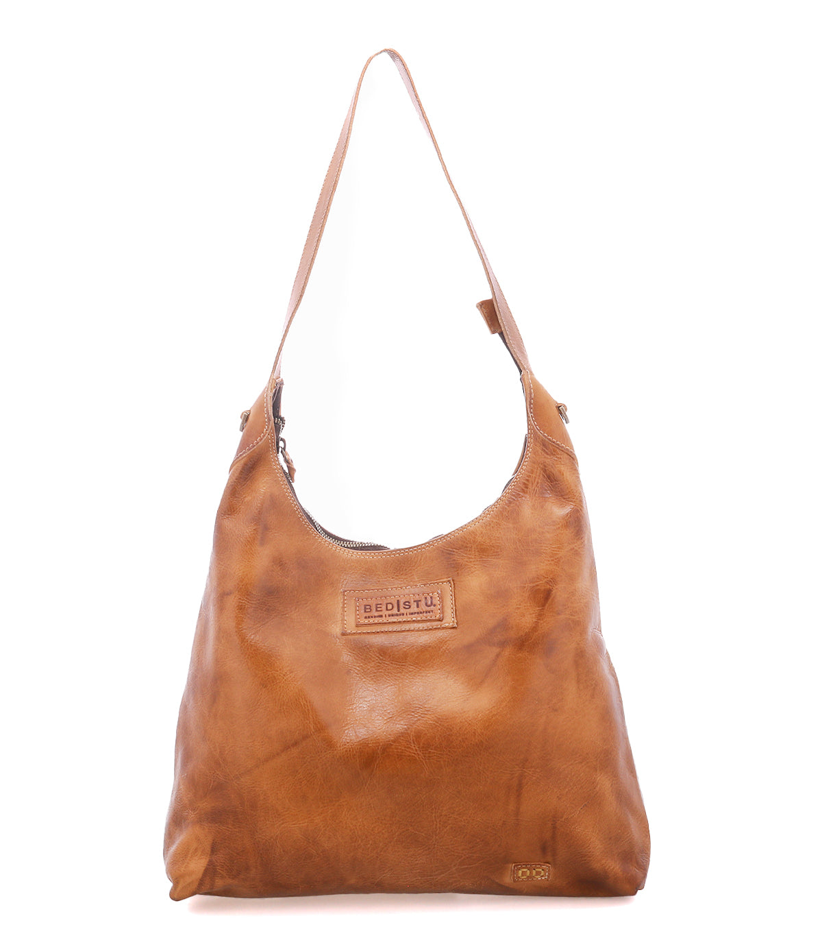 Crafted by Bed|Stü, the Dallas LTC is a tan leather shoulder bag with a single strap and visible stitching, highlighted by a rectangular embossed logo patch on the front—a holster-inspired design that seamlessly combines classic style and practical function.