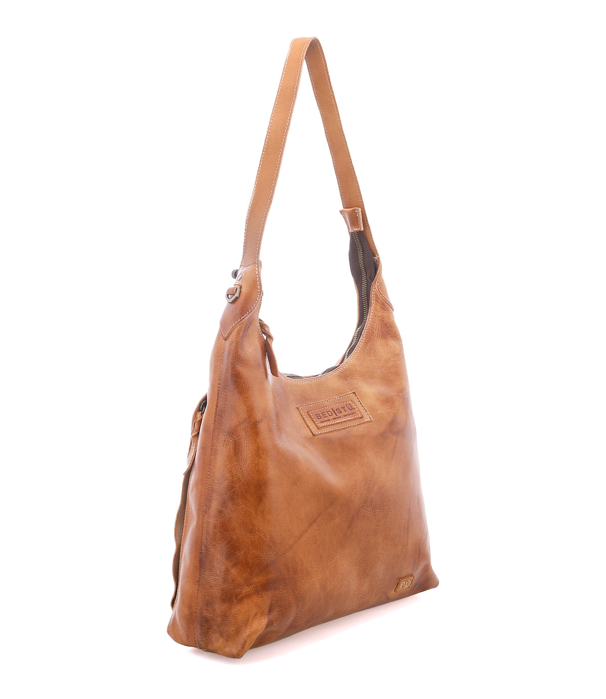 A brown leather shoulder bag with a single strap, stitched details, and a branded patch on the front is shown against a white background—this versatile Bed|Stü Dallas LTC concealed carry bag blends style and security for everyday use.