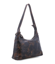The Denton by Bed|Stü is a distressed brown vegetable-tanned leather shoulder bag featuring a single strap, zip-top closure, and visible stitching, shown against a white background.