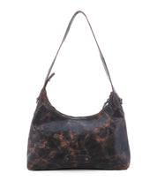The Bed|Stü Denton is a brown, distressed vegetable-tanned leather shoulder bag featuring a single strap, zip-top closure, and a front logo patch, shown against a white background.