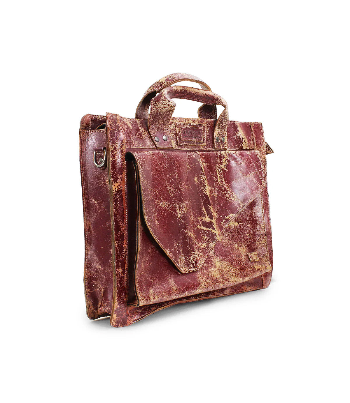 The Bed|Stü Depp is a distressed brown leather briefcase with top handles, a front flap pocket, and metal hardware. It features organized compartments and an adjustable shoulder strap for added versatility, shown against a white background.