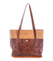 The Bed|Stü Dome tote is a two-tone brown leather bag with long handles, chevron stitching on the top section, and a small logo patch on the front. Designed with a spacious interior to hold all your work essentials, it is photographed against a white background.