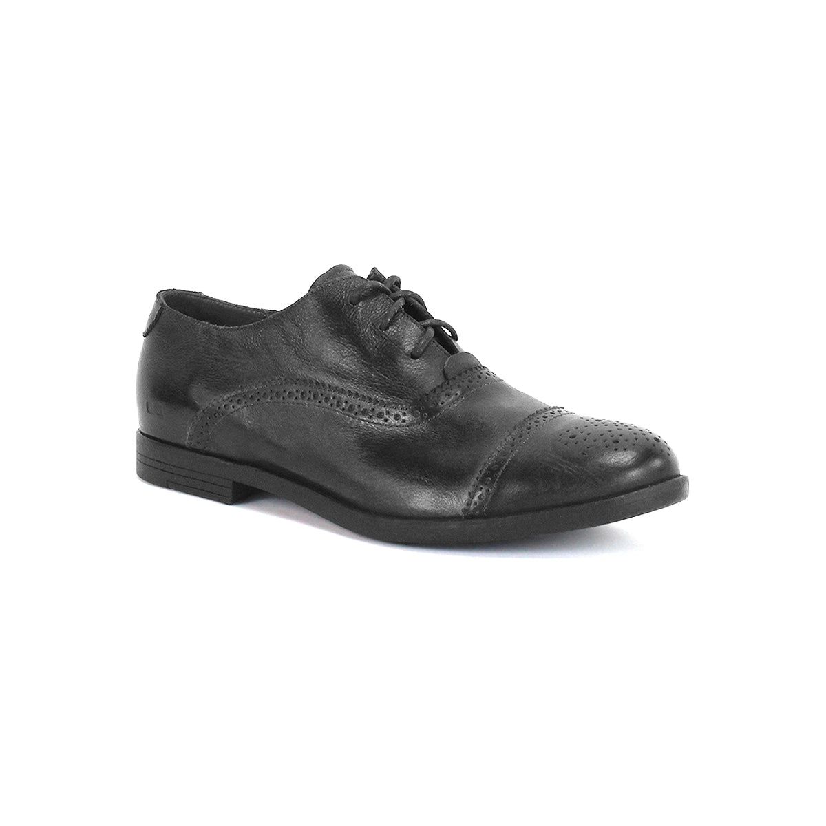 The Bed|Stü Donatello II is a black leather oxford shoe with a cap-toe design and brogue detailing, crafted from vegetable-tanned leather and featuring a low heel with laces, displayed against a white background.