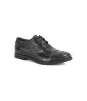 The Bed|Stü Donatello II is a black leather oxford shoe with a cap-toe design and brogue detailing, crafted from vegetable-tanned leather and featuring a low heel with laces, displayed against a white background.