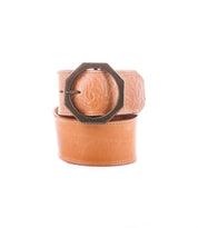 The Dreampath EM by Bed|Stü is a tan genuine leather belt featuring a subtle embossed pattern and a large, dark octagonal metal buckle, combining rugged durability with modern style against a white background.