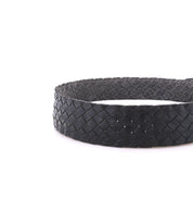 A close-up of the Bed|Stü Dreamweaver black woven leather belt, expertly showcasing artisan craftsmanship, displayed against a plain white background.