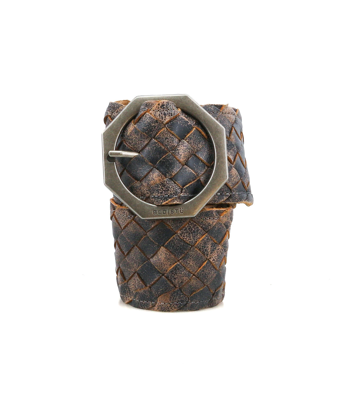 The Dreamweaver belt by Bed|Stü features woven dark brown leather and an octagonal metal buckle, highlighting artisan craftsmanship as it stands upright against a white background.
