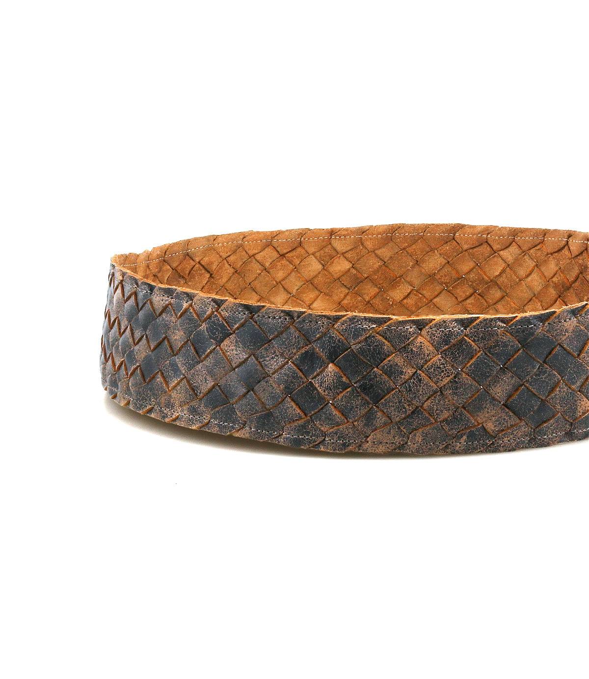 A close-up of the Bed|Stü Dreamweaver belt, expertly coiled to highlight its textured woven leather pattern against a white background, showcases the artisan craftsmanship behind this stylish bohemian accessory.