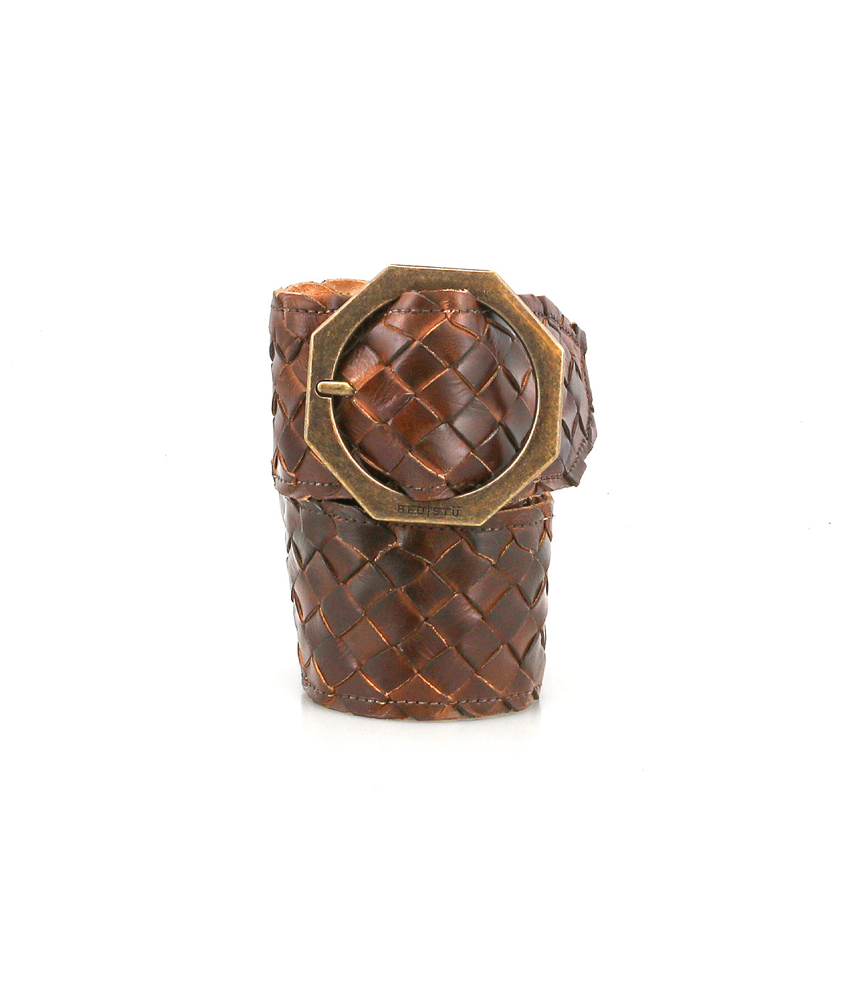 The Dreamweaver bracelet by Bed|Stü showcases artisan craftsmanship and bohemian style with its wide brown woven leather band, accented by a large octagonal brass buckle, and is displayed upright against a white background.