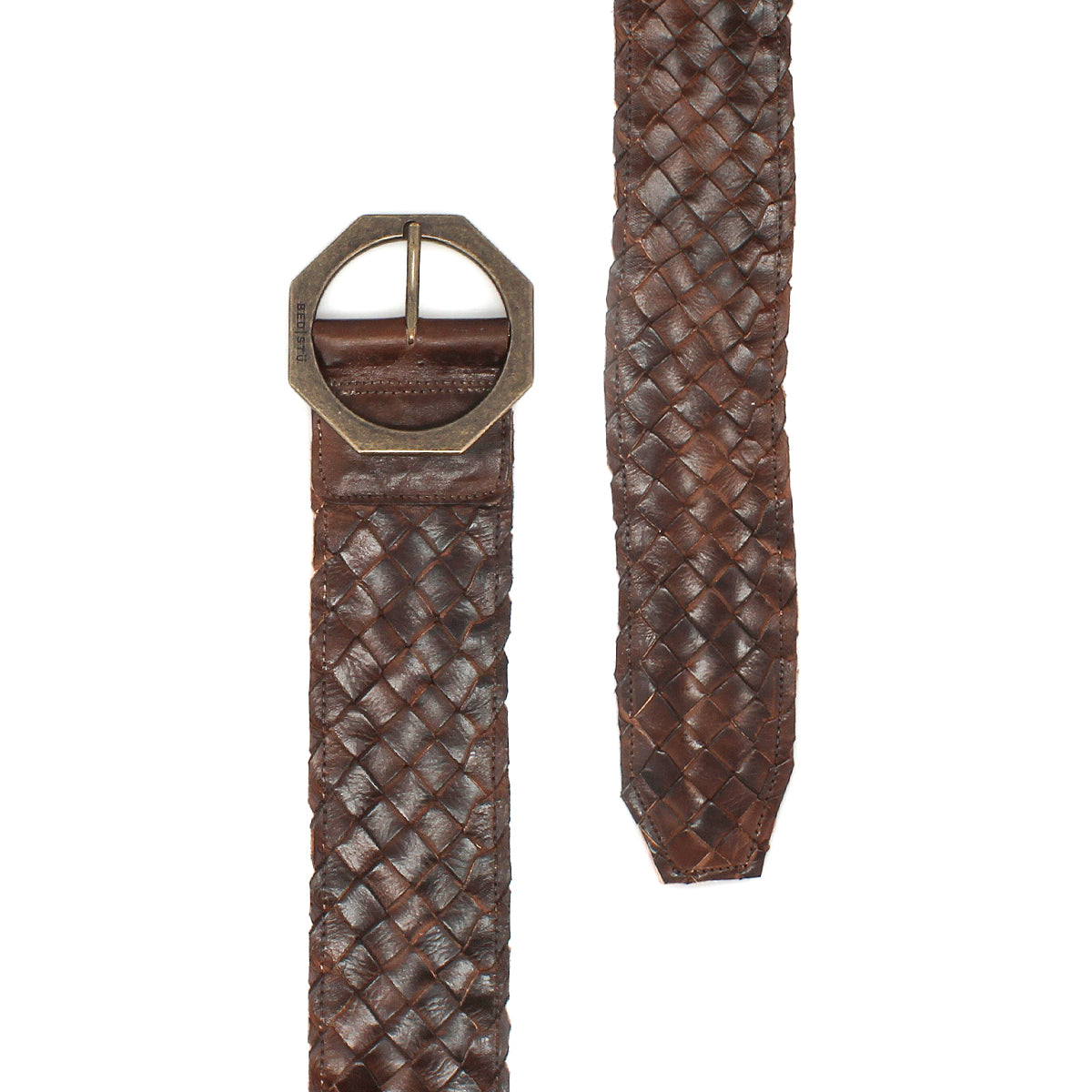 The Bed|Stü Dreamweaver brown woven leather belt, featuring artisan craftsmanship and a geometric metal buckle for a bohemian touch, is shown on a white background with both the buckle end and the tapered tip visible.