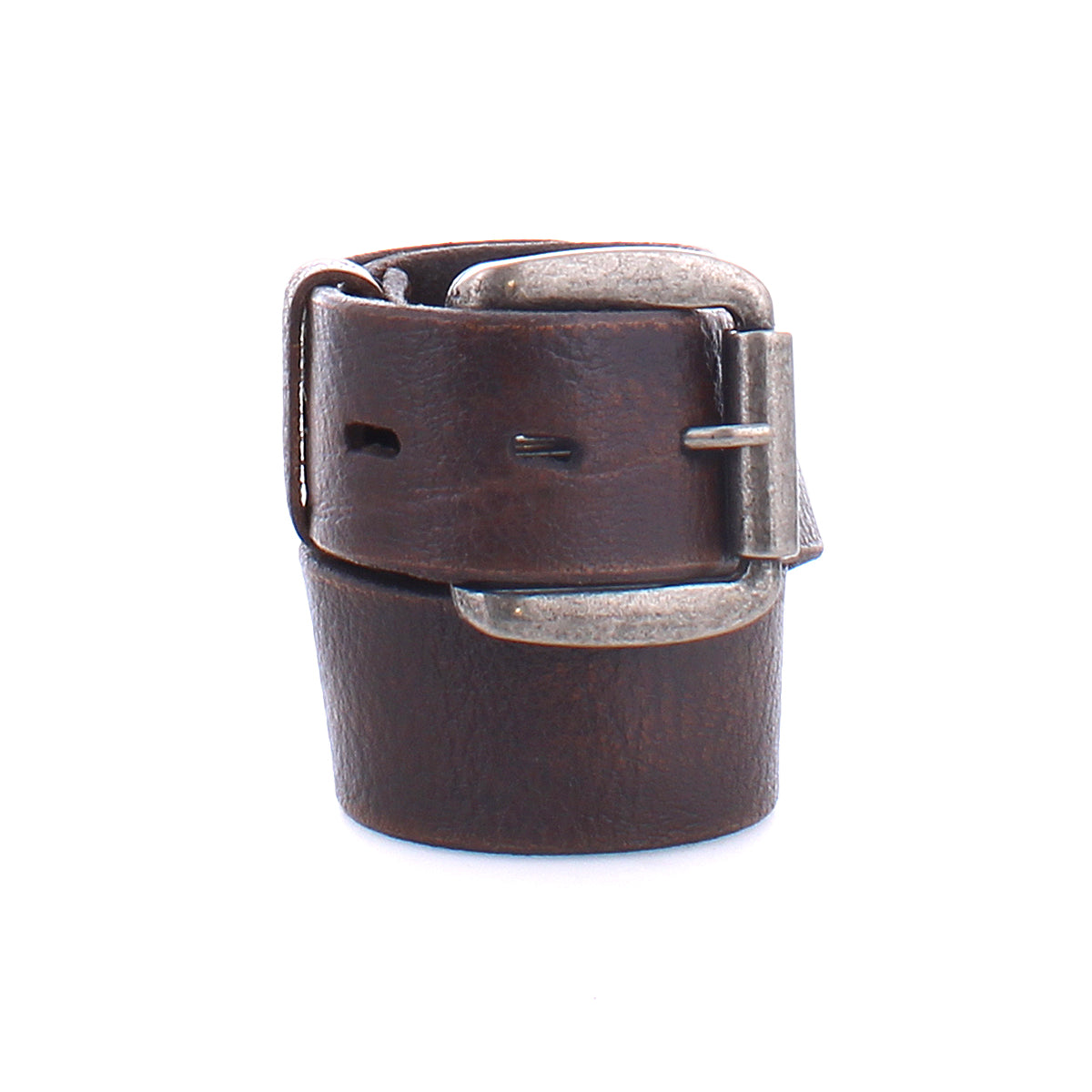 The Drifter belt by Bed|Stü is shown coiled against a white background, featuring a textured dark brown leather strap and a silver metal buckle in a minimal style.