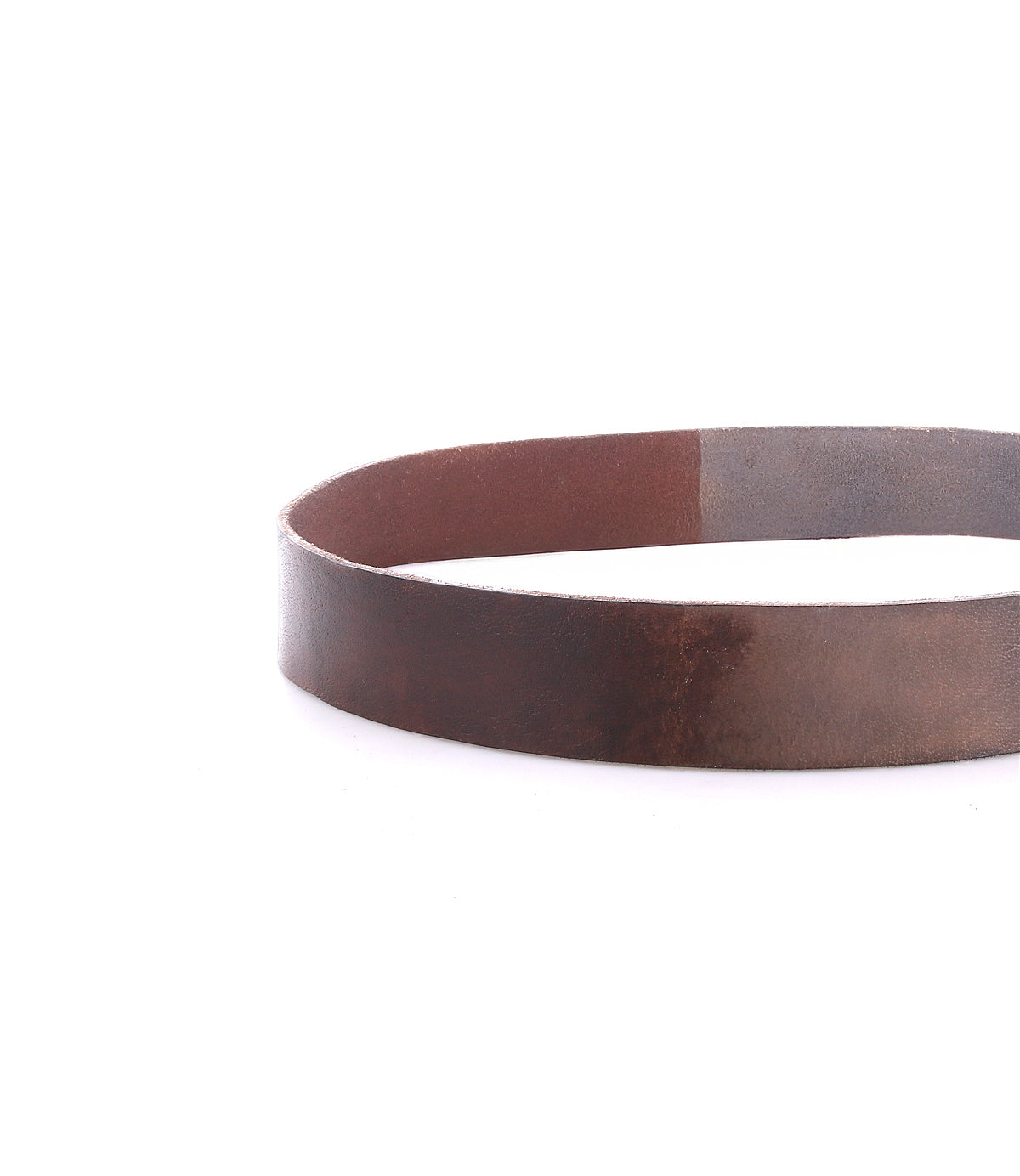 The Drifter by Bed|Stü is a brown leather belt with a textured leather strap, shown coiled in an oval shape on a white background for a minimal style look.