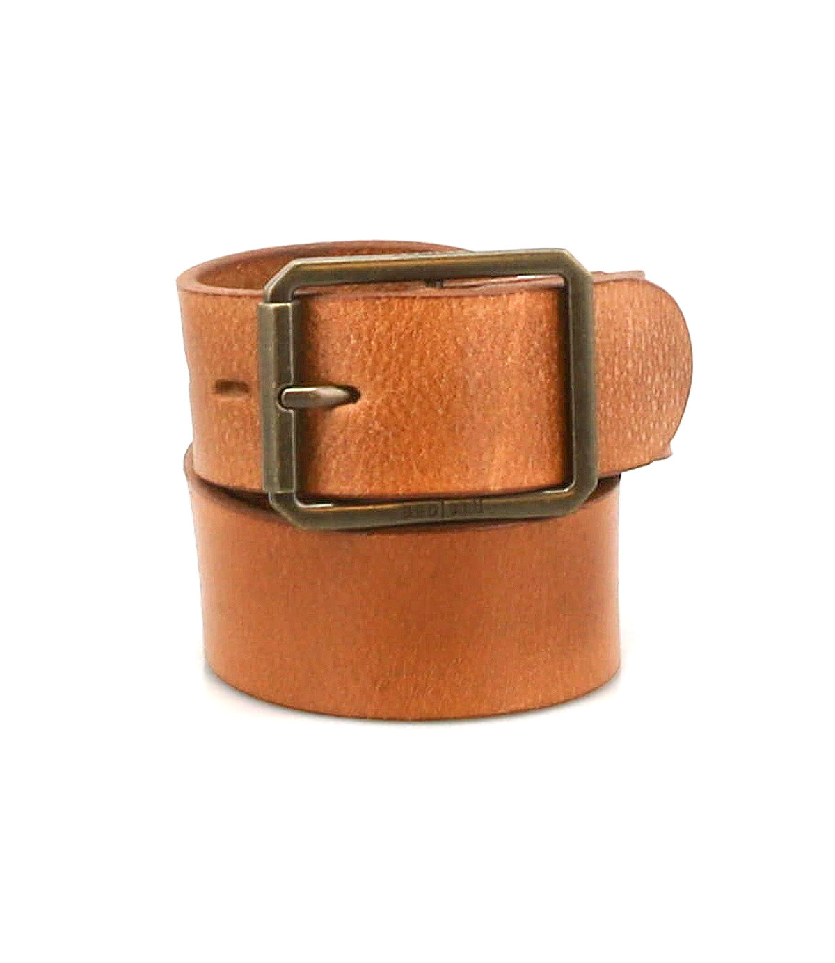 The Drifter belt by Bed|Stü is a tan textured leather strap, rolled up and featuring a rectangular metal buckle, showcased in a minimal style against a white background.