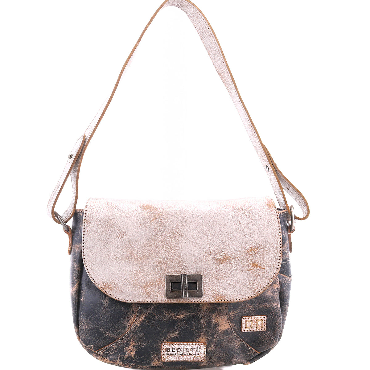 The Elect shoulder bag by Bed|Stü is a two-tone leather accessory with a flap closure, adorned with a rectangular metal clasp and a short strap, seamlessly combining vintage charm and everyday practicality.