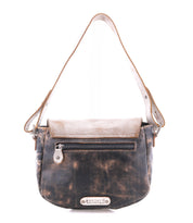 The Bed|Stü Elect is a distressed brown leather shoulder bag featuring a front zipper pocket, flap closure, and a metal brand plate at the bottom front, offering vintage charm perfect for everyday use.