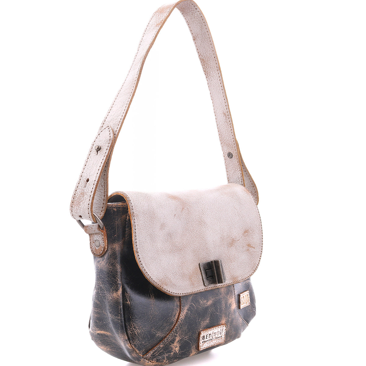 The Bed|Stü Elect is a distressed leather shoulder bag featuring a light flap, adjustable strap, and metal buckle; it exudes vintage charm and is perfect for everyday use, photographed against a white background.