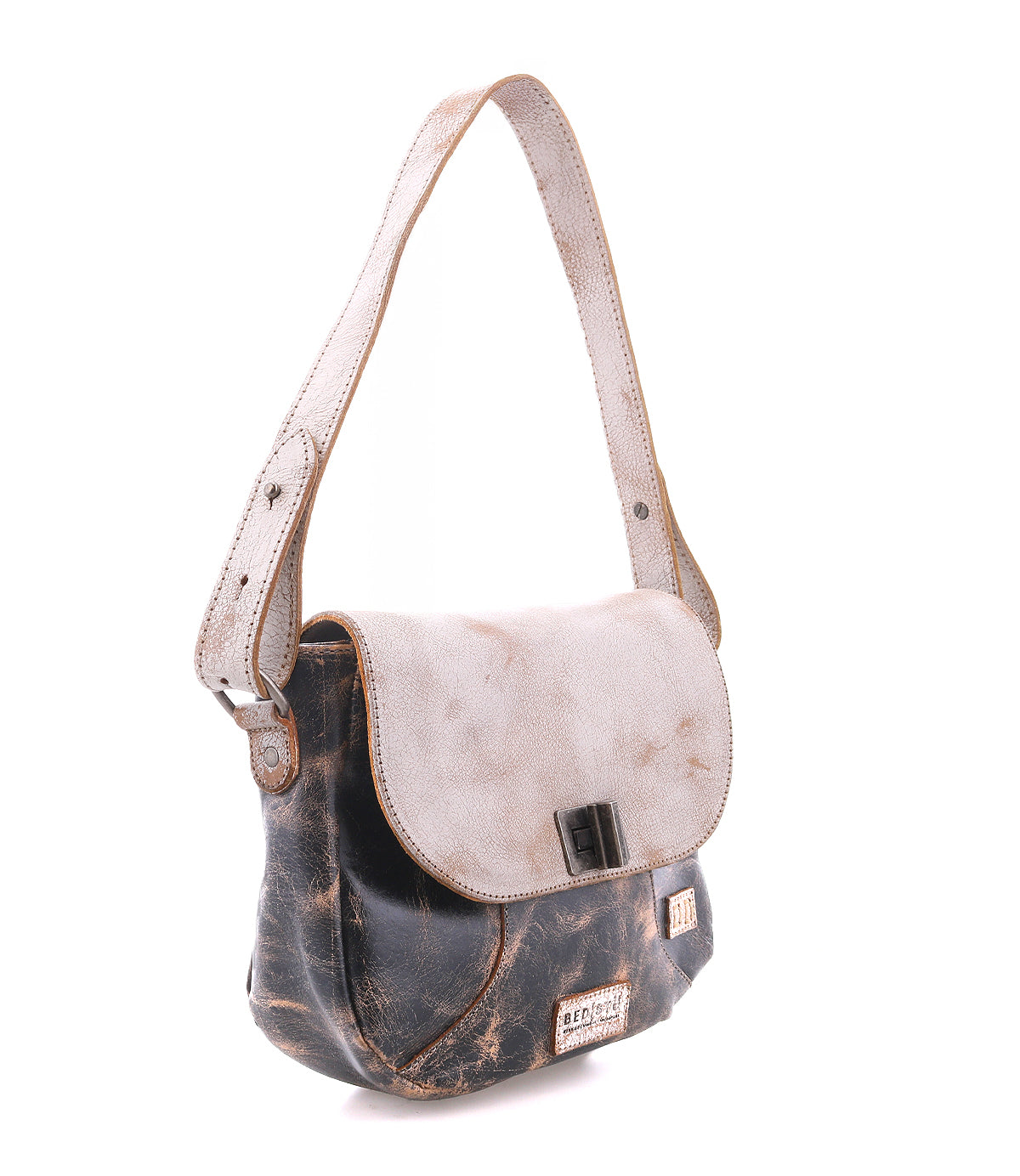 The Bed|Stü Elect is a distressed leather shoulder bag featuring a light flap, adjustable strap, and metal buckle; it exudes vintage charm and is perfect for everyday use, photographed against a white background.