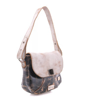 The Bed|Stü Elect is a distressed leather shoulder bag featuring a light flap, adjustable strap, and metal buckle; it exudes vintage charm and is perfect for everyday use, photographed against a white background.