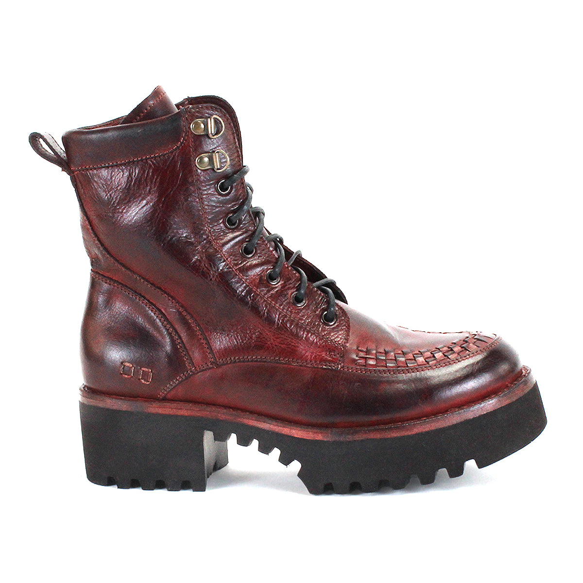 The Elisha Hi by Bed|Stü is a single burgundy leather lace-up boot featuring a chunky black sole, metal eyelets, and a handwoven toe detail that brings artisanal texture to its classic silhouette.