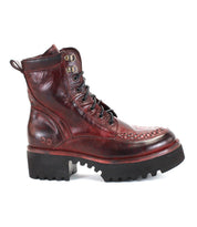 The Elisha Hi by Bed|Stü is a single burgundy leather lace-up boot featuring a chunky black sole, metal eyelets, and a handwoven toe detail that brings artisanal texture to its classic silhouette.