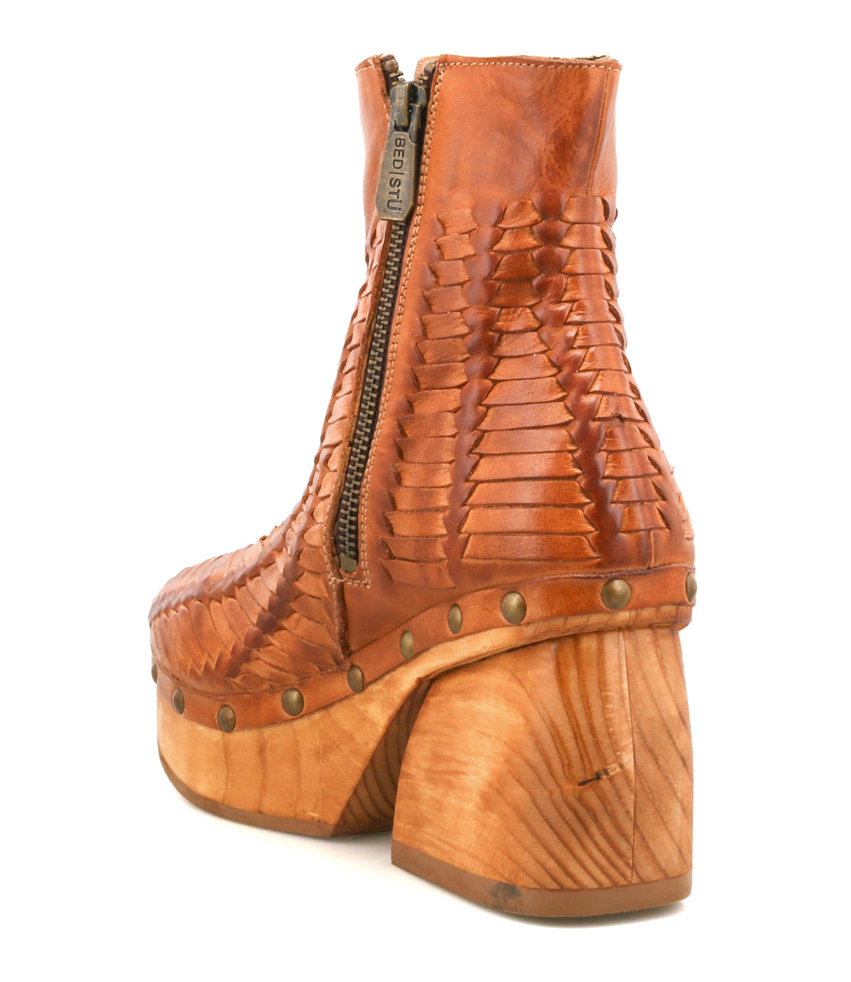The Ellasphin ankle boot by Bed|Stü features tan woven leather, a side zipper, stud accents, and a chunky wooden heel—an artisan-inspired take on sculptural style footwear.