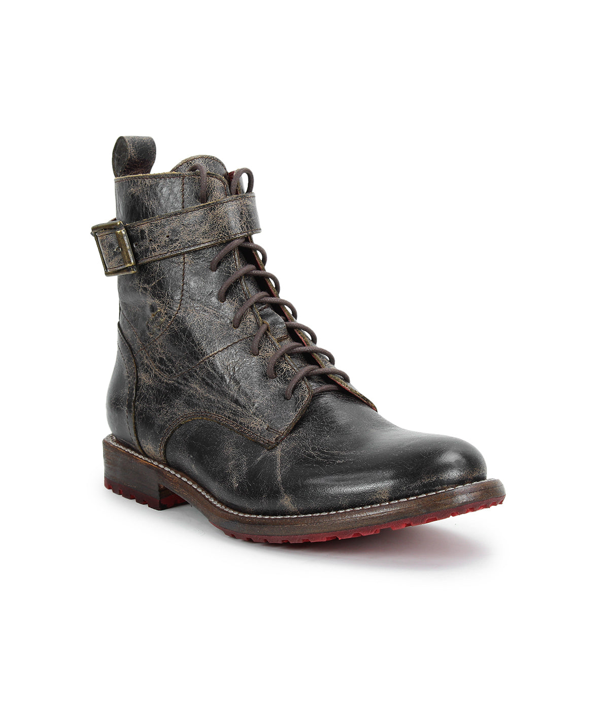 The Bed|Stü Endure is a single black leather lace-up boot with a textured finish, side buckle strap, and low heel, displayed on a white background. This rugged leather boot features a durable treaded outsole for enhanced grip and long-lasting wear.