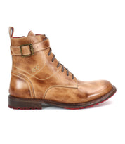The Bed|Stü Endure is a brown leather lace-up boot with a side buckle and low heel, featuring a durable treaded outsole for reliable grip. Shown in profile against a white background, these rugged ankle strap boots stand out with their bold red tread for striking contrast.