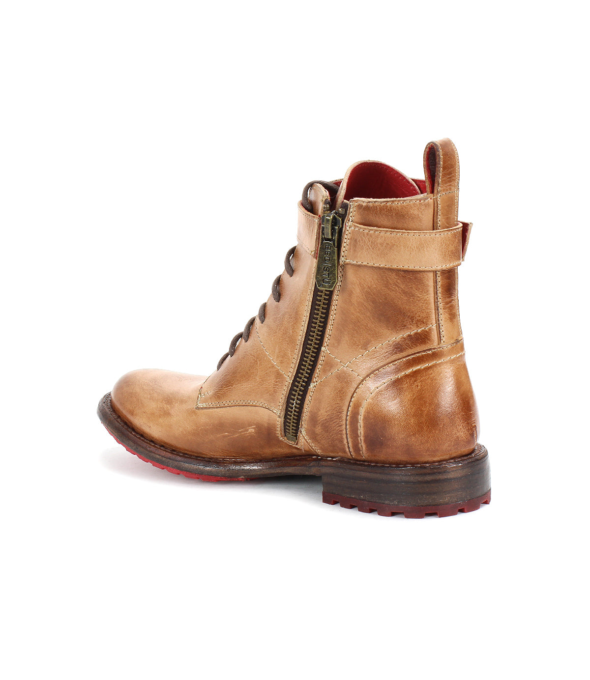 The Bed|Stü Endure is a tan leather ankle boot with a side zipper, lace-up front, and red sole detail, featuring a durable treaded outsole for added grip, shown from a rear-side angle on a white background.