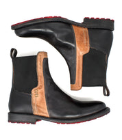A pair of "Ethic" Chelsea boots by Bed|Stü in black leather, featuring brown side panels, striking red soles, and black elastic gussets. Leather-lined for enhanced comfort, these durable boots are displayed in both side profile and top-down views—an ideal blend of style and function.