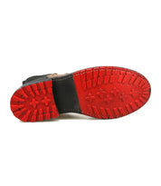 The Bed|Stü Ethic boot is displayed with its sole facing upward, showcasing a durable Chelsea design with a red rubber sole featuring deep treads and cross-shaped patterns.