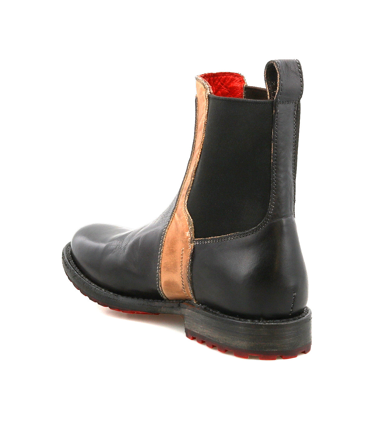 Bed|Stü Ethic is a black leather-lined Chelsea boot featuring a tan side panel, elastic gusset, striking red interior lining, and a black sole with durable red traction detail, displayed from a rear side angle on a white background.
