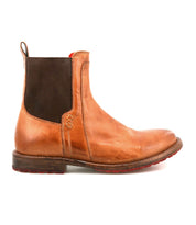 Introducing Ethic by Bed|Stü—a brown Chelsea boot lined with leather, featuring a striking black elastic side panel, low heel, and distinctive red sole. Displayed in a side profile against a white background, this durable and stylish classic offers exceptional comfort and sophistication.