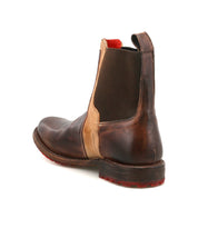The Bed|Stü Ethic is a durable brown leather Chelsea boot featuring a tan side panel, leather-lined interior, pull tab, elastic gusset, and rugged sole, shown from the rear view.