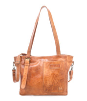 Light brown leather shoulder bag with a front patch pocket, detachable strap, and stitched detailing, the Bed|Stü Explicit LTC bag radiates rustic appeal and everyday dependability, displayed against a white background.