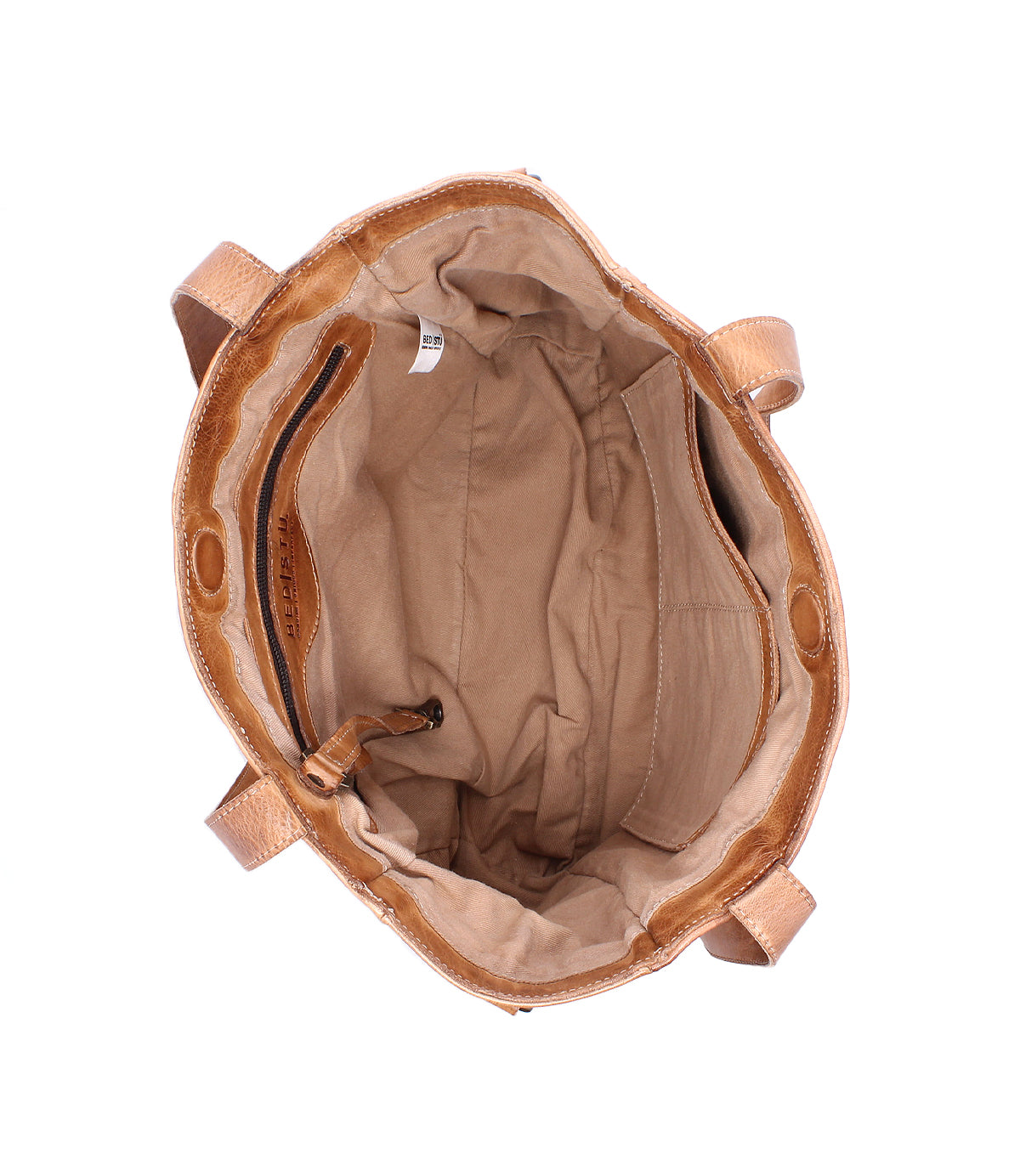 Top view of the open Bed|Stü Explicit LTC tote bag in tan leather, featuring a beige fabric lining, an interior zippered pocket, and two sturdy handles—highlighting its rustic charm and everyday reliability.