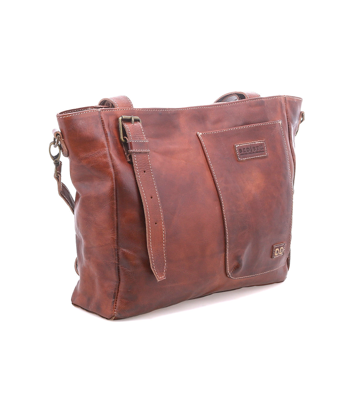 Bed|Stü Explicit LTC brown leather shoulder bag featuring a rectangular silhouette, front pocket, adjustable strap, and visible stitching. Finished with a branded patch on the front, this bag combines rustic charm with everyday dependability for lasting style.