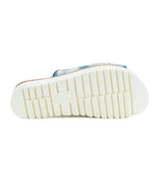 The Bed Stu Fairlee II features a flatform leather slide sandal with a grooved white rubber outsole and blue patterned detail on the upper side.