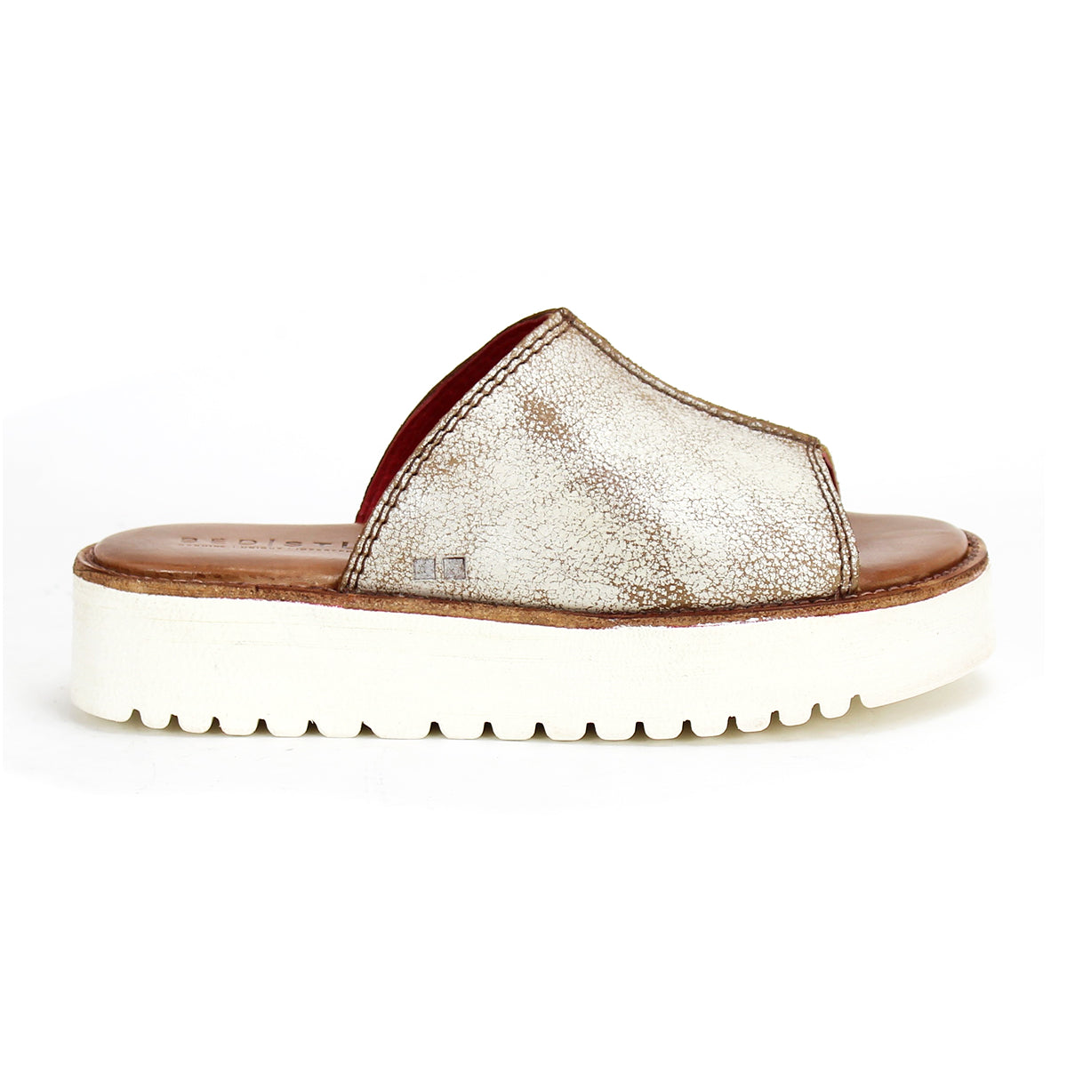 The Bed|Stü Fairlee II is a metallic silver slip-on slide sandal featuring an open toe, a wide upper strap, a brown cushioned footbed insole, and a thick white platform sole with ridged tread.