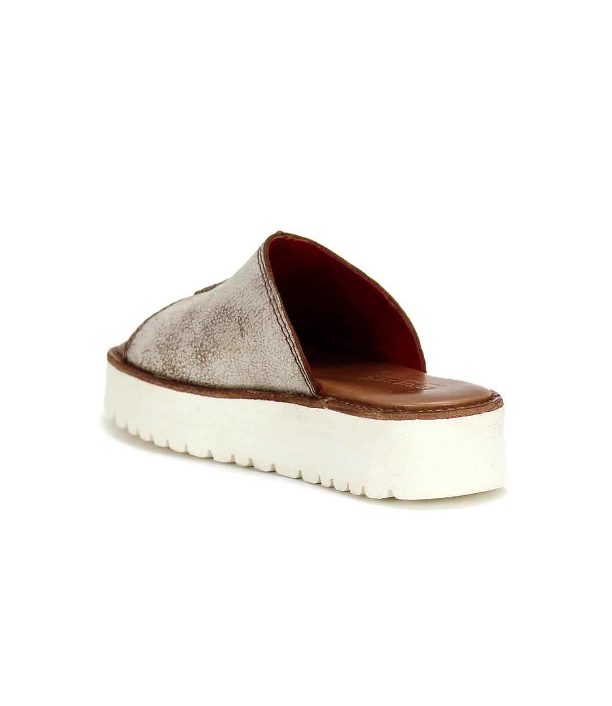 The Bed|Stü Fairlee II is a slip-on sandal with a textured brown upper and a thick white sole, featuring a cushioned footbed, shown from the back left angle.
