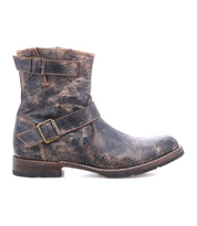 Meet Fellow by Bed|Stü—a rugged, distressed brown leather ankle moto boot featuring two buckled straps, a low stacked heel, round toe, and visible stitching. Expertly crafted with Goodyear welt construction for lasting durability, it’s shown here in a side profile view—an essential staple for any modern wardrobe.