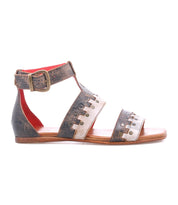 The Bed|Stü Fibril is a brown leather bohemian sandal, crafted from hand-woven leather, featuring an ankle strap with buckle closure and decorative cutout details on the straps, shown here in a side view.
