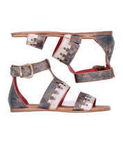 The Fibril sandals by Bed|Stü are flat, open-toe bohemian sandals crafted from distressed brown and metallic silver leather, featuring decorative cutouts, an adjustable strap, and a gold buckle fastening.