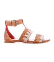 The Bed|Stü Fibril sandal is a brown leather bohemian flat with an adjustable ankle strap and buckle, two decorative hand-woven leather cutout straps across the foot, and a red inner lining, shown in a side view against a white background.