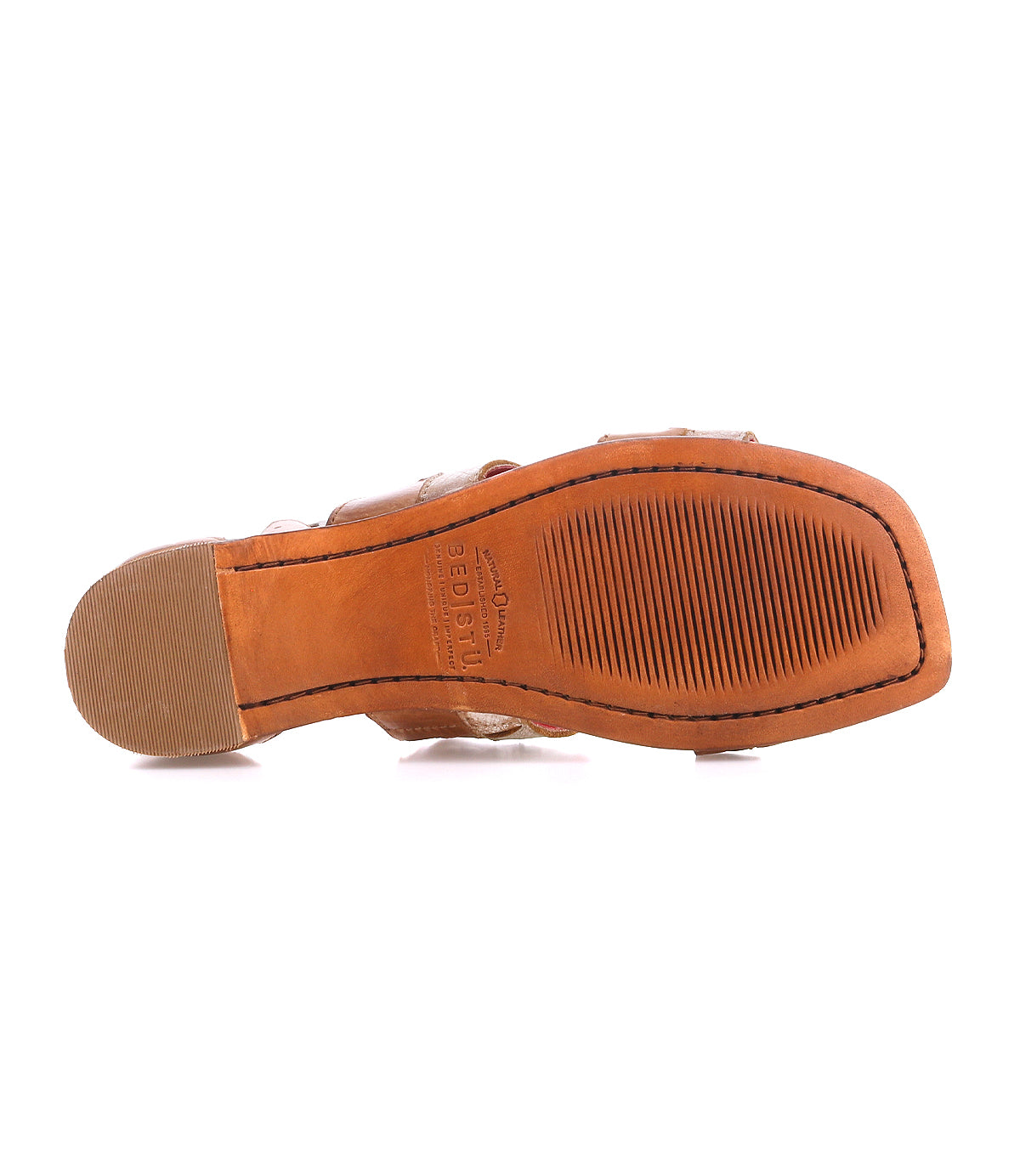 The image shows the bottom view of the Bed|Stü Fibril sandal, which features a textured rubber sole and a low heel with hand-woven leather details. The sandal is displayed against a white background.