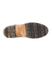 The image shows the bottom view of the Bed|Stü Fierce washed leather derby dress shoe, featuring a leather and textured rubber sole with visible tread patterns and a durable Goodyear welt.