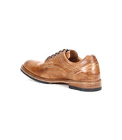 A rear-side view of the Bed|Stü Fierce brown washed leather derby dress shoe, featuring a black sole and Goodyear welt, displayed on a white background.