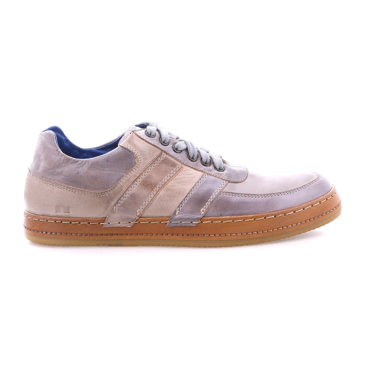 The Firepower sneaker by Bed|Stü is a taupe and gray low-top everyday shoe featuring a brown textured sole, suede and leather stripe accents, side stitching, and gray laces. Shown in profile view on a white background.